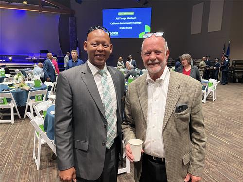 BOE member Tommy Overcash standing with Assistant Supt. Eric Terrell